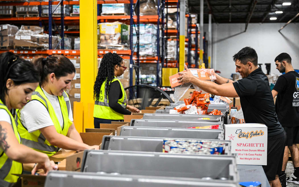 Volunteers assemble relief packages for Hurricane Melissa at the Global Empowerment Mission headquarters in Miami, Florida, on October 27, 2024. Hurricane Melissa threatened Jamaica with potentially deadly rains after rapidly intensifying into a top-level Category 5 storm, as residents scrambled for shelter from what could be the island's most violent weather on record. Melissa has already been blamed for at least four deaths in Haiti and the Dominican Republic, and was set to unleash torrential rains on parts of Jamaica in a direct hit on the Caribbean island. (Photo by CHANDAN KHANNA / AFP)