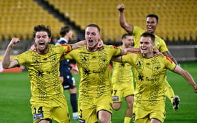 Finn Surman of the Phoenix celebrates with team-mates after scoring a goal
