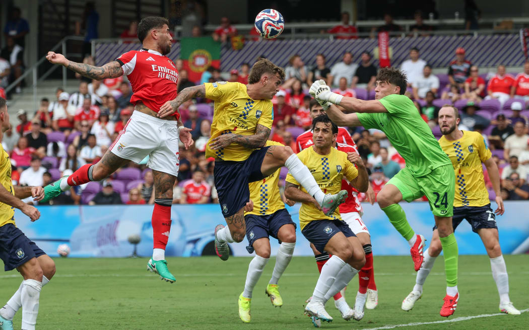 Auckland City FC goalkeeper Nathan Garrow (R) clears against Benfica.