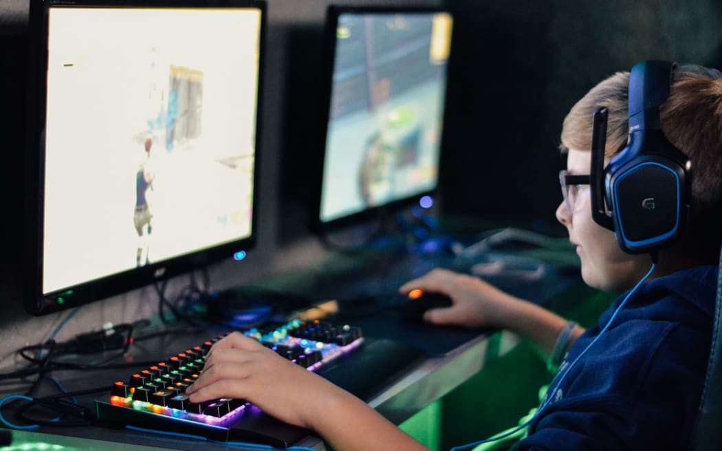 A young person engaged in gaming