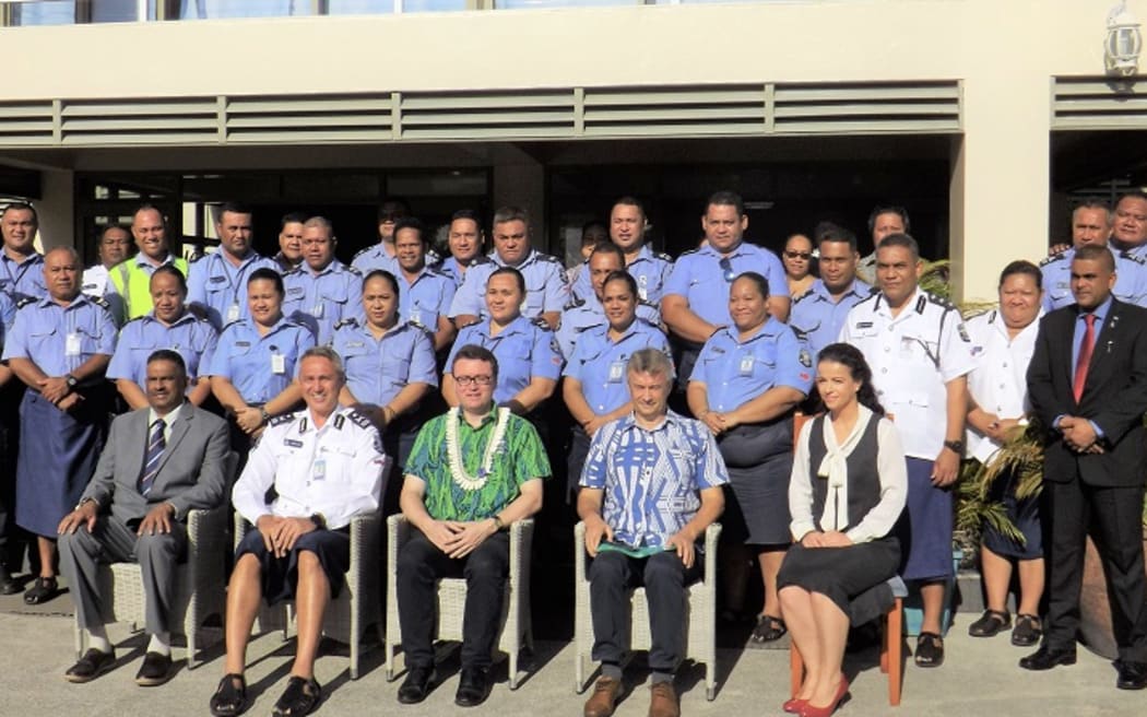 The British High Commissioner, (front centre), the Police Commissioner, (front left in white) and UNDP Representatives alongside officers at the training