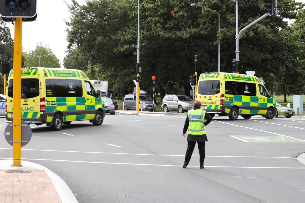 Ambulances leave the scene of the shooting.
