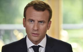 French President Emmanuel Macron speaks to journalists after he signed the controversial rail reform, at the Elysee Palace in Paris, on June 27, 2018. / AFP PHOTO / POOL / JULIEN DE ROSA