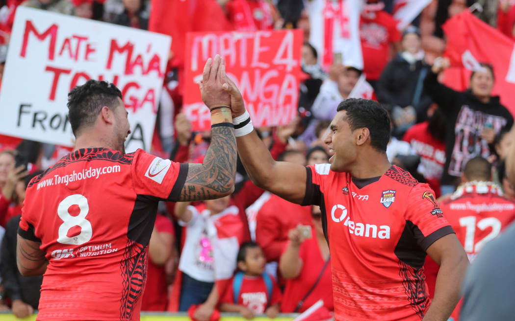 Tonga's Andrew Fifita and Tevita Pangai Junior celebrate their upset win over the Kiwis at the 2017 World Cup.