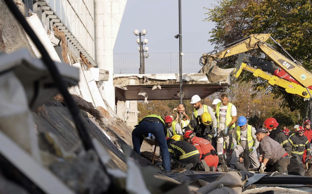 In this handout photograph taken on November 1, 2024 and released by the Ministry of Interior Affairs of Serbia and shows emergency and rescue teams working at the site where a concrete outdoor roof of a train station collapsed in the northern Serbian city of Novi Sad. - At least eight people were killed November 1, 2024 after part of an outdoor roof collapsed at a train station in the Serbian city of Novi Sad, the interior minister said. (Photo by MINISTRY OF INTERRIOR AFFAIRS OF SERBIA / AFP) / RESTRICTED TO EDITORIAL USE - MANDATORY CREDIT 