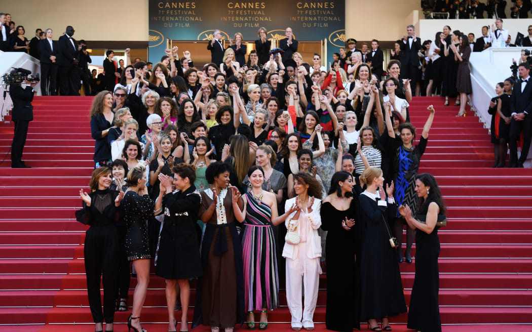 Directors, actresses and industry representatives pose on the red carpet in protest of the lack of female filmmakers honored throughout the history of the festival.