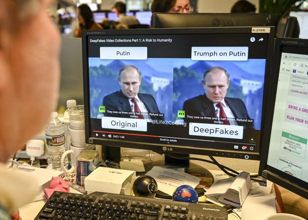An AFP journalist views a video on 25 January, 2019, manipulated with artificial intelligence to potentially deceive viewers, or "deepfake" at his newsdesk in Washington, DC.