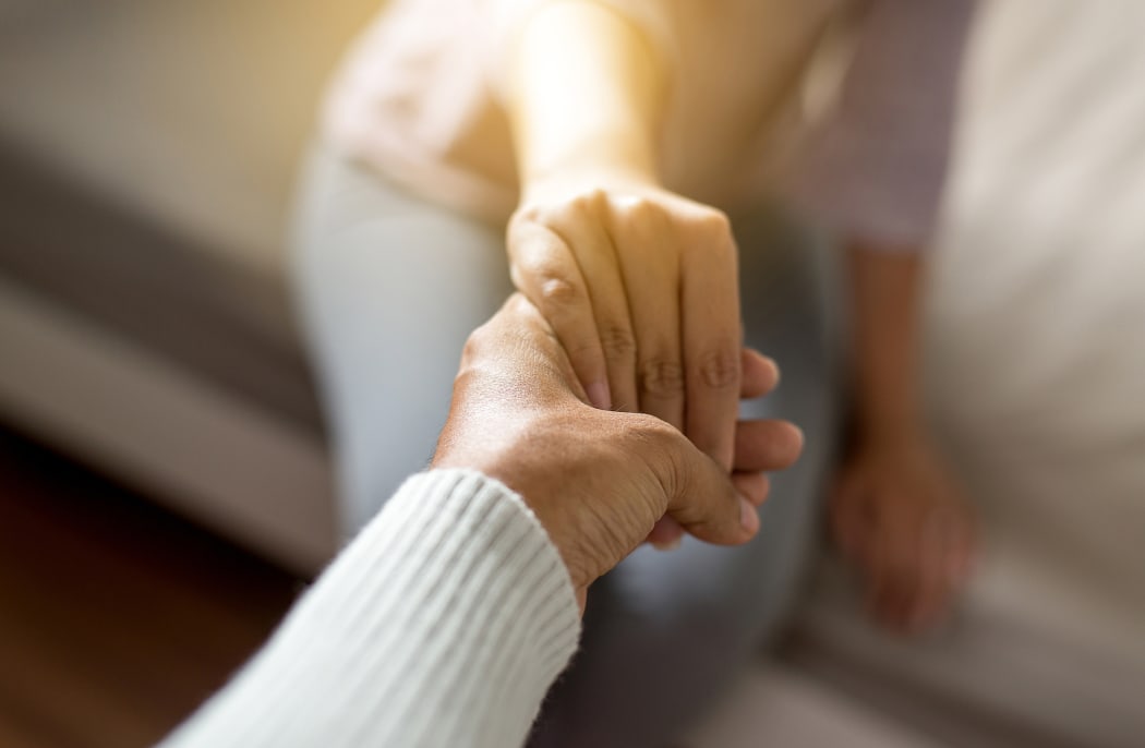 Man giving hand to depressed woman,Psychiatrist holding hands patient,Meantal health care concept,Selective focus