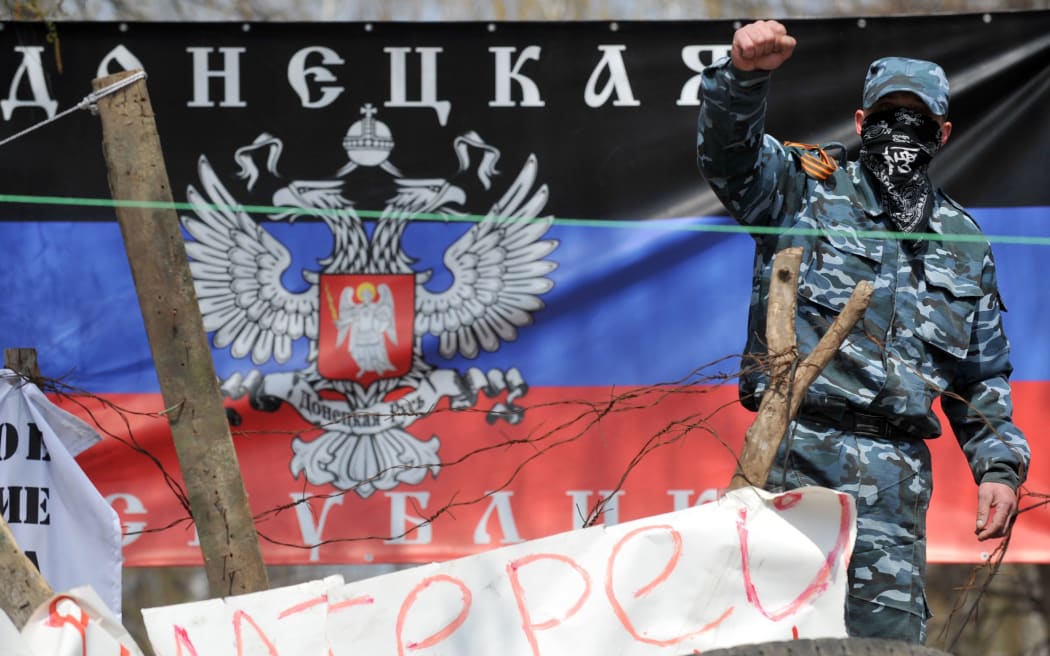 A pro-Russia activist guards a barricade outside the regional police building in Slavyansk.