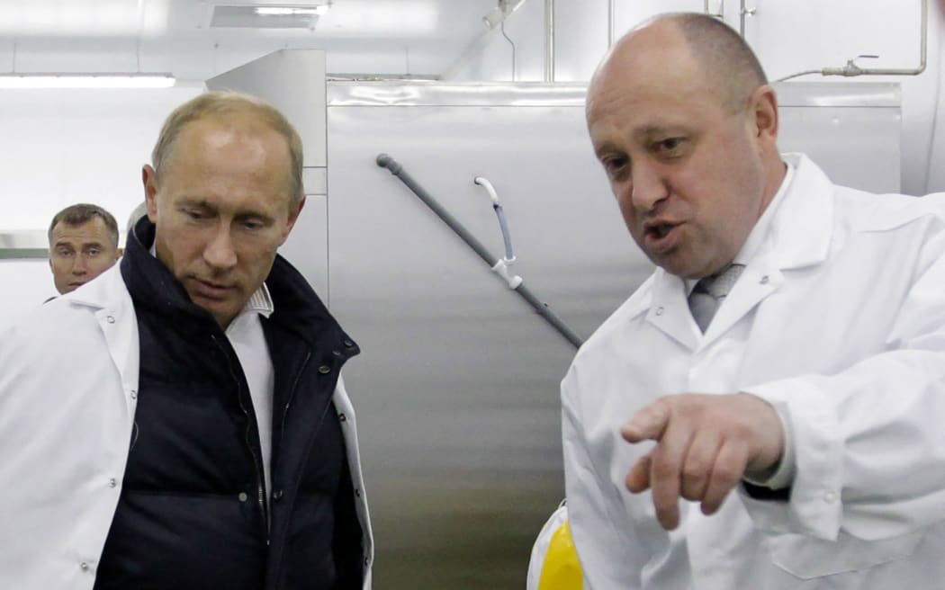 Businessman Yevgeny Prigozhin shows Russian Prime Minister Vladimir Putin his school lunch factory outside Saint Petersburg on 20 September 2010.