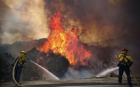 San Miguel County Firefighters battle a brush fire along Japatul Road during the Valley Fire in Jamul, California on September 6, 2020