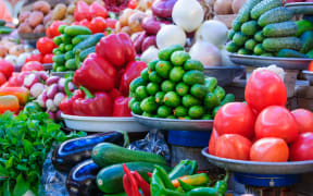Variety of fresh organic vegetables on the market. Tomato, onion, cucumber, pepper