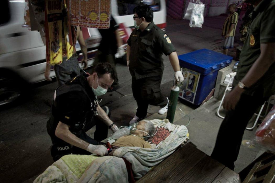 Waiting to rendezvous with the ambulance after transporting the patient through the slums.