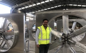 David Turner, Ceo of Sequal Lumber standing beside new equipment that will go into the new furnace at the mill