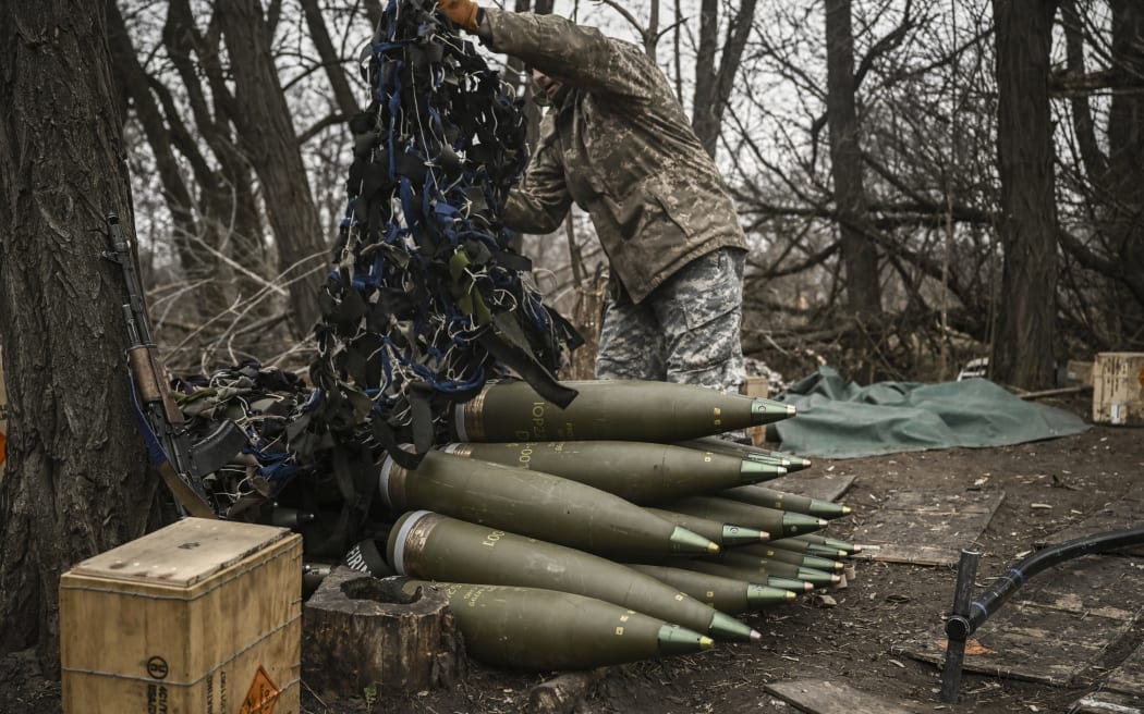 A Ukrainian serviceman prepares 155mm artillery shells near Bakhmut, eastern Ukraine, on 17 March, 2023, amid the Russian invasion of Ukraine.