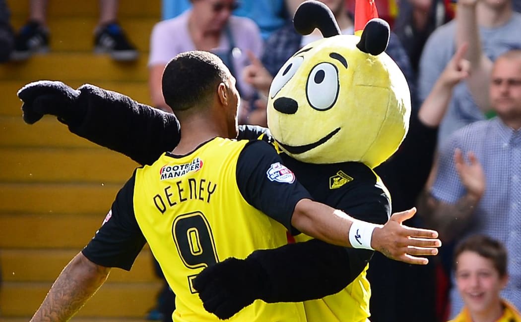 Watford's Troy Deeney celebrates with the club mascot after scoring.