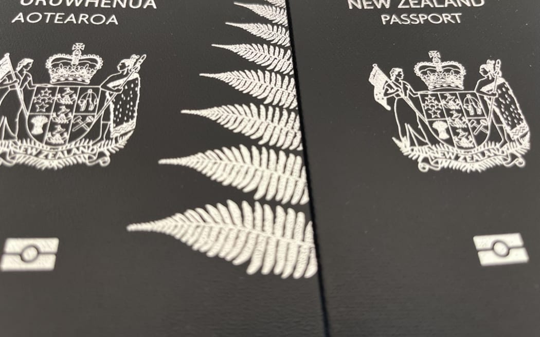 A 2016 and a 2023 New Zealand passport. The older passport features the English words first - a design the government says it will change back to with new passports from 2027.