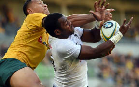 Fiji's Kini Murimurivalu tries to tackle Australia's Israel Folau.