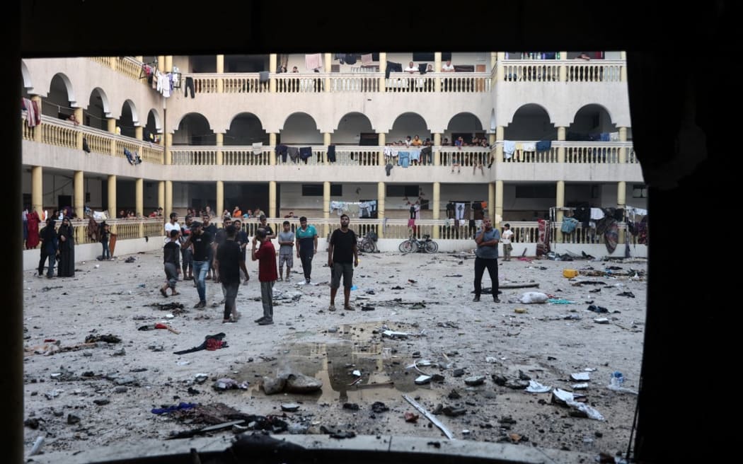 Displaced Palestinians gather in the yard of a school hit by an Israeli strike in Gaza City on August 10, 2024, that killed more than 90 people. (Photo by Omar AL-QATTAA / AFP)