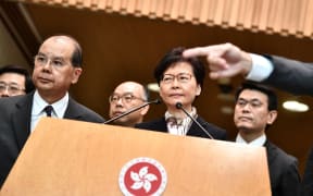 Hong Kong Chief Executive Carrie Lam (C) listens to a question during a press conference in Hong Kong.