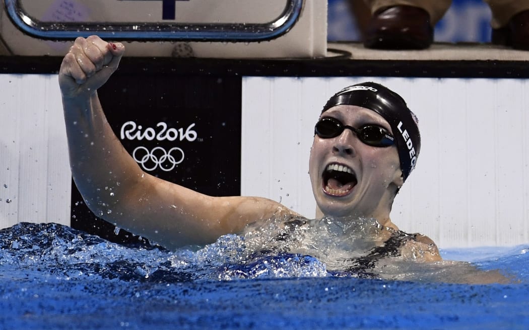 US swimmer Katie Ledecky celebrates breaking her own world record for the women's 400m freestyle at the Rio 2016 Olympic Games on 8 August 2016 (NZT).