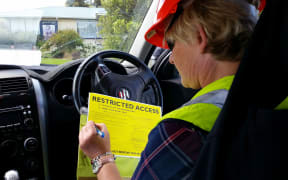 Marlborough district council building inspector Cherie Newman fills out a yellow restricted access placard for a badly damaged house in Ward, south Marlborough .