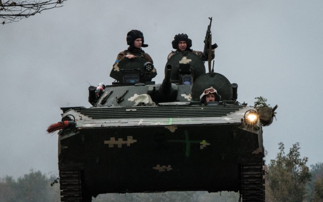 Ukrainian soldiers drive an armoured personnel carrier (APC) in Kupiansk, in the recently retaken area near Kharkiv on September 30, 2022.