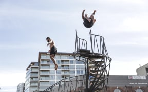 Summer in Wellington, people jump into the harbour.
