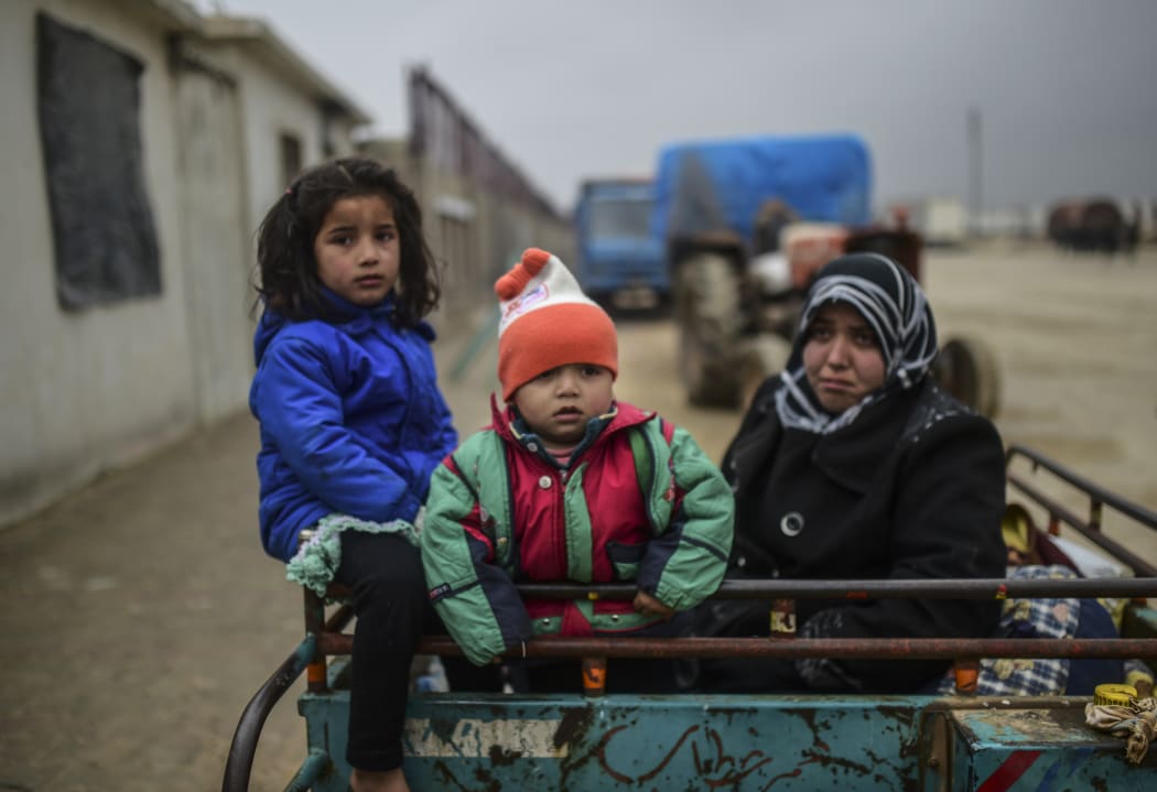 Refugee children arrive at the Turkish border crossing gate.