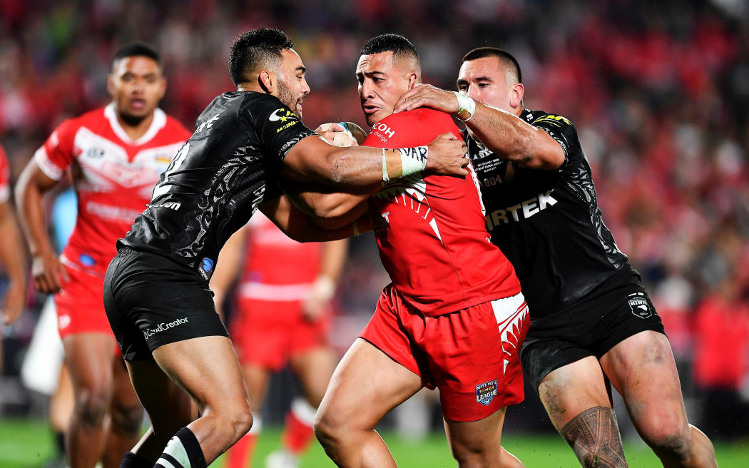 Sio Siua Taukeiaho is wrapped up by the New Zealand defence.