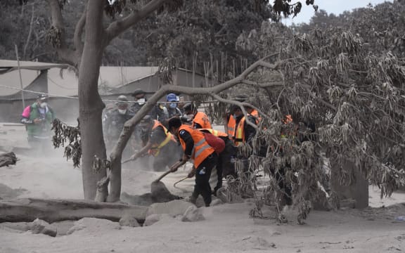 Members of Guatemalan Army and police officers, search for victims in the ash-covered village of San Miguel Los Lotes, in Escuintla department, about 35 km southwest of Guatemala City, two days after the eruption of the Fuego Volcano, on June 5, 2018.