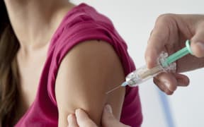 A young woman receives a dose of HPV vaccine Gardasil.