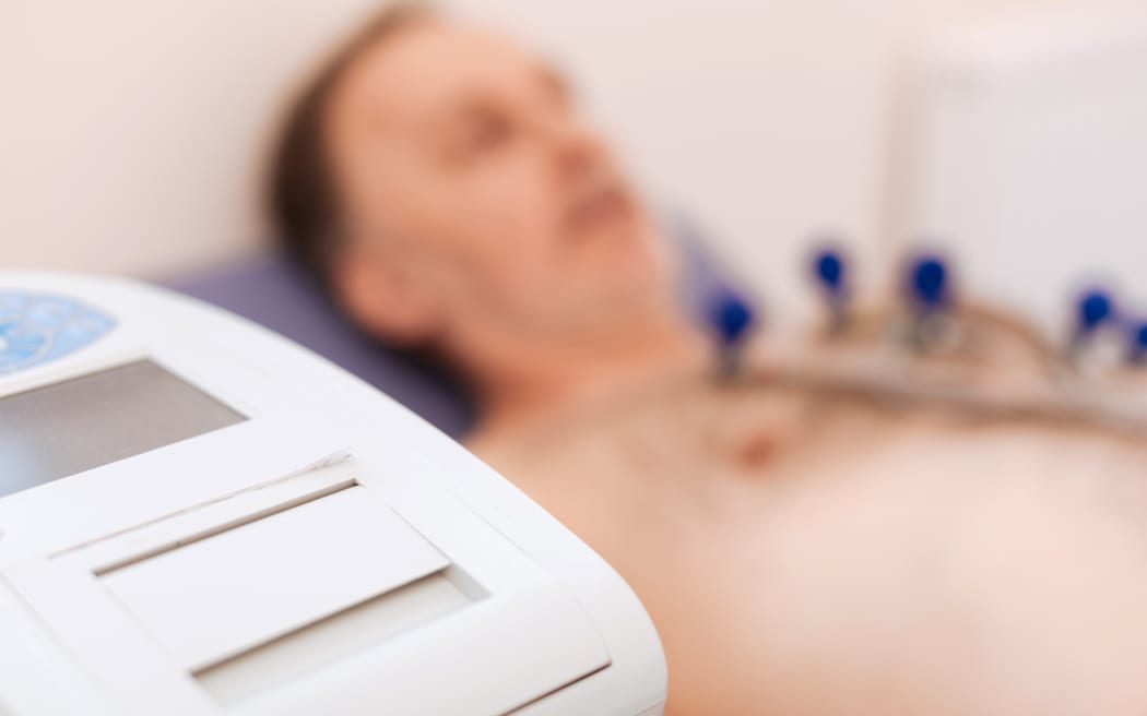 Magical machinery. Man making sure his heart is functioning without problems by examining it using special equipment