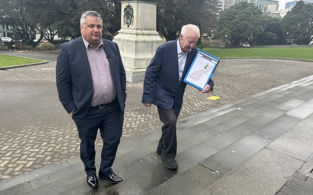 Patient Voice Aotearoa's Malcolm Mulholland (left) and his father George Mulholland deivers a petition to Parliament today calling on the Government to urgently fix the staffing shortages at Buller Hospital.