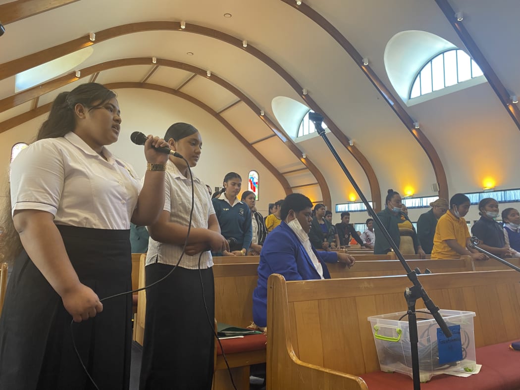 An Auckland church congregation prays for their family in Tonga.