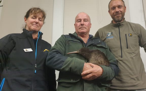 Taranaki Kiwi Trust's Sue Hardwick-Smith, truck driver Alan Pennington and Simon Collins, sanctuary manager at Rotokare Scenic Reserve with Papa the kiwi.