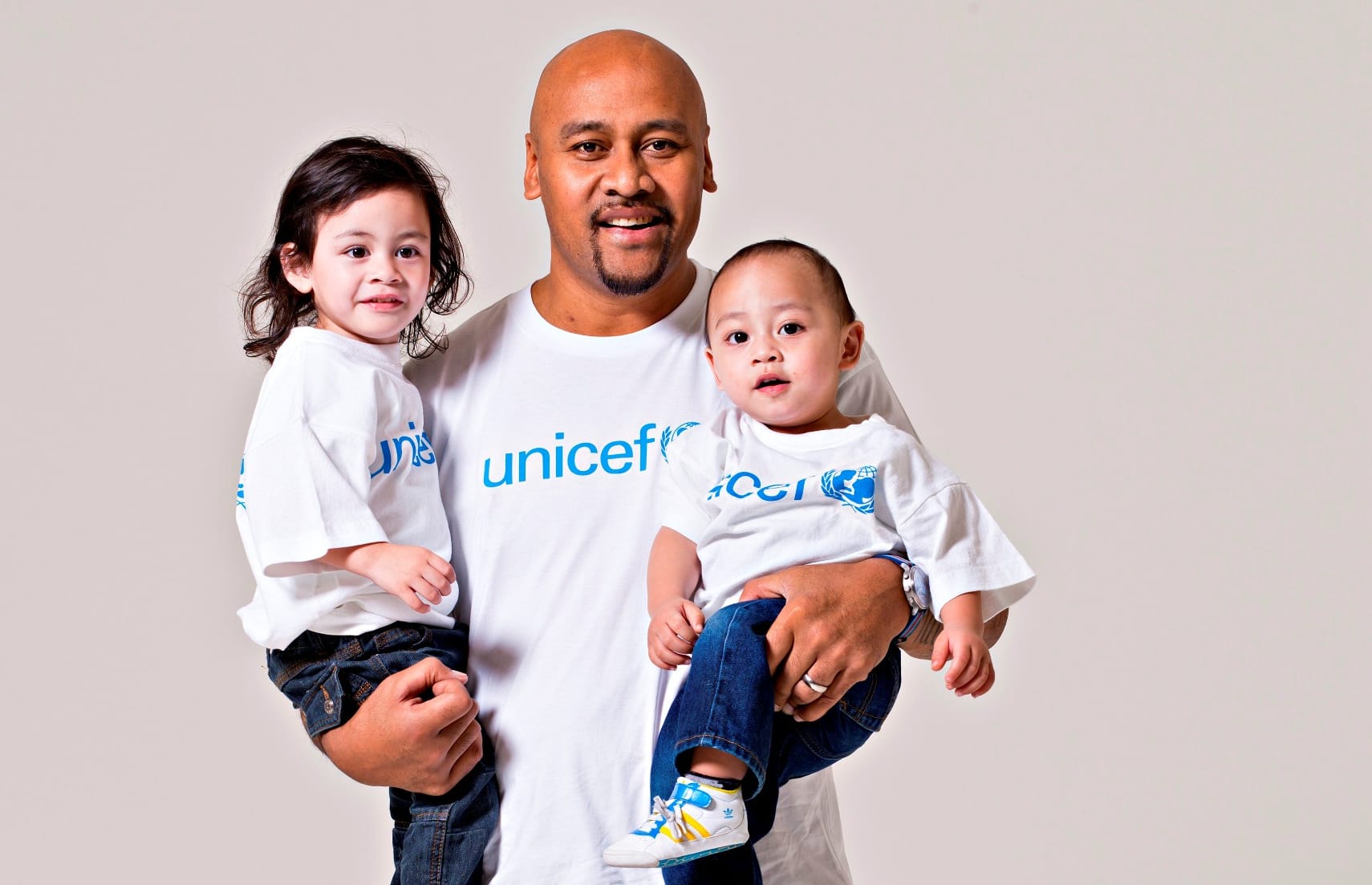 Jonah Lomu - pictured with his sons Brayley and Dhyreille - supported several charities, including UNICEF.