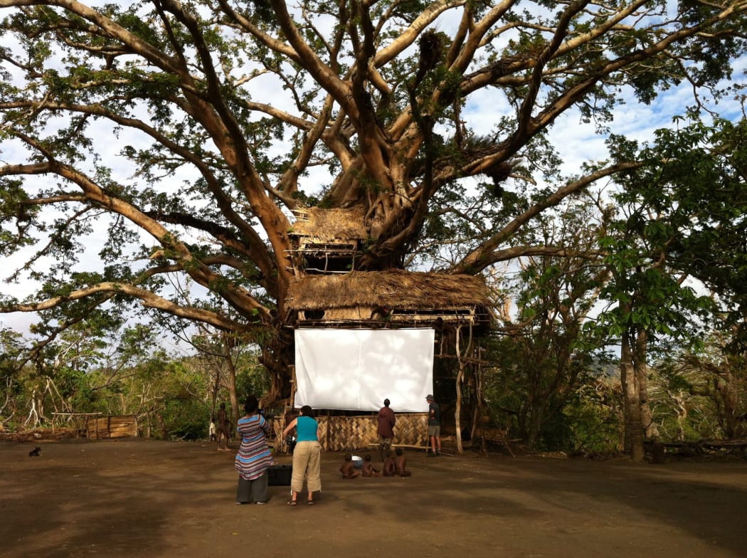 The cinema screen (2 sheets we'd brought attached to a giant banyan tree that somehow survived Cyclone Pam) constructed by the 'can do mob' of Yakel village, just weeks after the cyclone. Incredibly they insisted we come back to show the film as planned.  - Contact Films