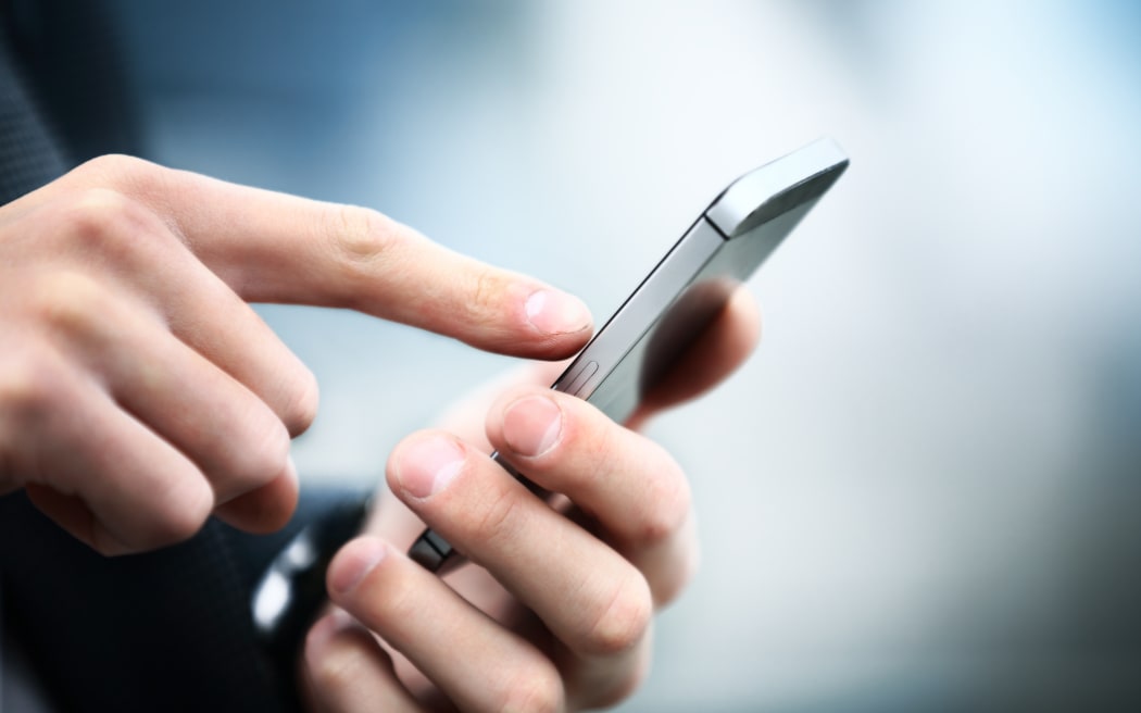 Close up of a man using mobile smart phone