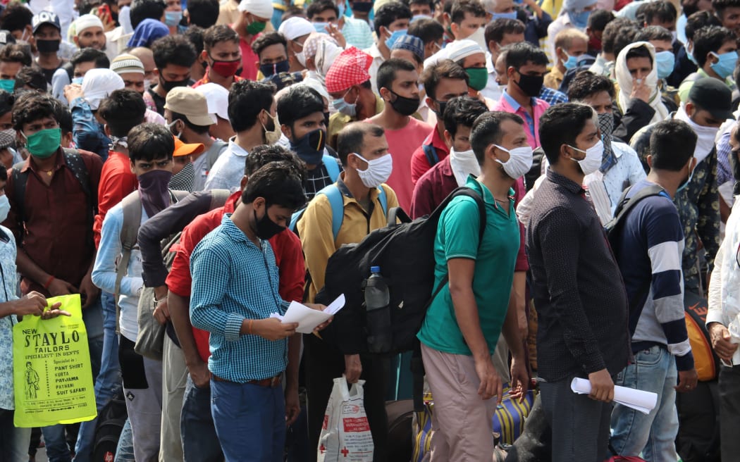 Migrants wait to board buses to reach their homes in Mumbai, India on May 15, 2020.