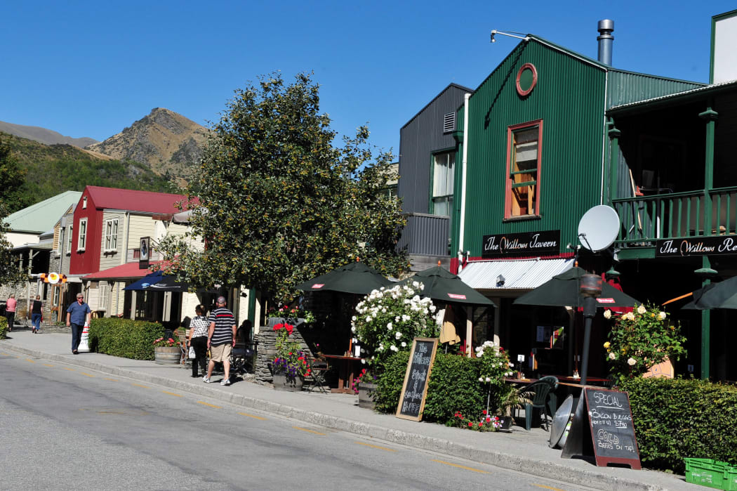 ARROWTOWN, NZ - FEB 10: Visitors in Arrowtown on February 10 2009. Arrowtown is a historic gold mining town in the Otago region of the South Island of New Zealand.