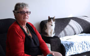 Jenni Schreuder and her cat Bobby in her Vevian Place flat.