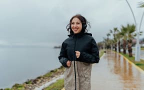 A woman exercising in the rain.