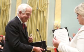 Canada's new Immigration, Citizenship and Refugees Minister John McCallum (L) is sworn-in as Prime Minister Justin Trudeau watches during a swearing-in ceremony at Rideau Hall in Ottawa on November 4, 2015.