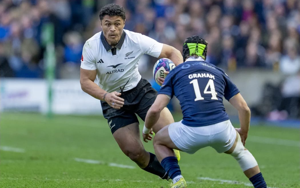 Caleb Clarke attempts to evade Darcy Graham of Scotland.