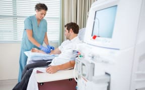 Nurse preparing dialysis patient (stock photo)