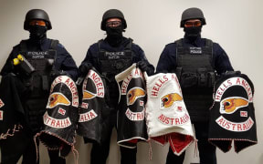 Some members of New South Wales Police's Strike Force Raptor team, with gang members' jackets.