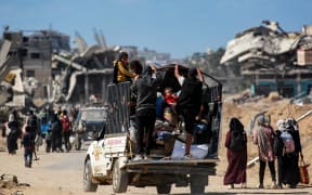 Displaced people arrive in Khan Yunis after being given notice by Israeli forces to evacuate from the eastern parts of the city in the southern Gaza Strip on October 7, 2024, on the first anniversary of the ongoing war in the Palestinian territory between Israel and Hamas. (Photo by BASHAR TALEB / AFP)