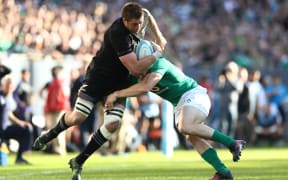 All Blacks player Liam Squire is tackled by Ireland player Andrew Trimble at Soldier Field on 5 November.