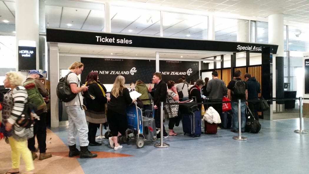 Air New Zealand passengers getting information after flights were cancelled.